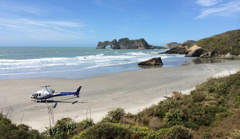 Landing the helicopter on a remote beach in Northwest New Zealand