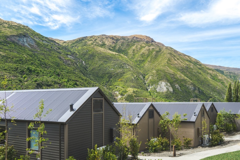 The Gibbston Valley Lodge villas with the Remarkables mountain range behind